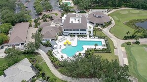 An aerial view of a resort with a swimming pool, golf course, and multiple buildings. - Cozy Condo on Golf Course/Summer Rental/ Fort Myers  (Fort Myers)