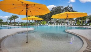 A pool area with multiple yellow umbrellas, lounge chairs, and a clear sky. - Cozy Condo on Golf Course/Summer Rental/ Fort Myers  (Fort Myers)