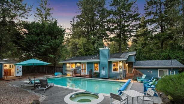 Una casa con piscina, mobiliario de exterior y jacuzzi.