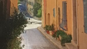 A narrow street with buildings on either side, featuring balconies and windows. - Warm, air-conditioned, 2-bedroom house 3 km from La Ciotat beaches. (Ceyreste)