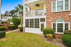 A two-story house with a balcony, a garage, and a well-maintained lawn.