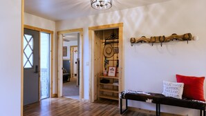 A wooden bench with a red pillow and a sign reading "WALK, TROT, CANTER, GALLOP, RUN FREE." - Big Sky Escape: Spacious Home on Working Ranch (Reed Point)