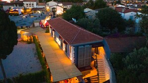 A building with a red-tiled roof, a covered outdoor seating area, and a satellite dish. - Cati Hotel Boutique Plus (Cesme)