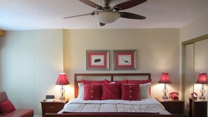 A bedroom with a wooden bed, two bedside tables with lamps, a ceiling fan, and two framed pictures on the wall. - 2BR/BA Silver Creek, Ski-in/out, Indoor/Outdoor Pool & Hot Tub (Snowshoe)