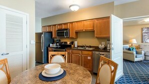 Enjoy meal preparation and dining in this well-equipped kitchen with a dining table and seating area.