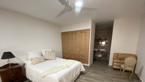 A bedroom with a bed, nightstand, lamp, wardrobe, and a chair. - RURAL HOUSE TOLEDO/MADRID (Borox)