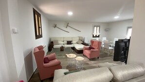 A modern living room with a sofa, two armchairs, a coffee table, and a television. - RURAL HOUSE TOLEDO/MADRID (Borox)