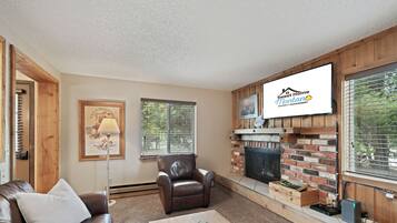 Townhome | Living area | 42-inch flat-screen TV with satellite channels, TV, fireplace