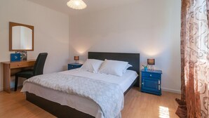 A neatly arranged bedroom with a bed, a desk, and a chair. - 2 bedroom awesome apartment in Sutivan (Sutivan)
