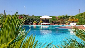 A clear blue pool with lounge chairs and a gazebo. - 2 bedroom lovely apartment in Frigole (Frigole)