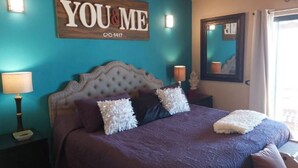 A bedroom with a large bed, a headboard, two bedside lamps, and a wall sign that reads "YOU & ME". - Villa 8 A Great Place to Relax and Create Great Memories! (Puerto Peñasco)