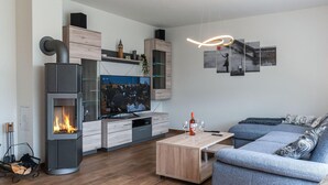 A modern living room with a fireplace, a flat-screen TV, a coffee table, and a sofa. - Amazing home in Bleckede with WiFi (Bleckede)