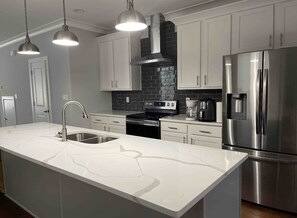 A modern kitchen with a large island, stainless steel appliances, and white cabinetry. - 5 mins from RIC , 5 mins from DT RVA (Richmond)