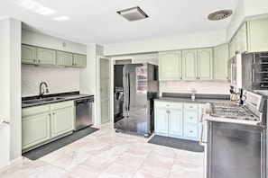 Enjoy cooking in this well-equipped kitchen with an oven, gas range, and stainless steel appliances.
