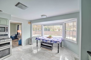 Enjoy meals in this kitchen with a microwave, oven, and dining table.