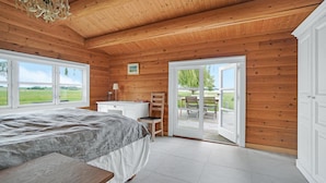 A bedroom with a bed, a desk, a chair, and a large window. - Stunning home in Skibby with WiFi (Skibby)