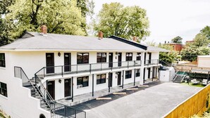 A two-story building with a flat roof, multiple windows, and a central staircase. - Luxe King Studio w/ Amazing View ~ Free Parking & WiFi (Memphis)