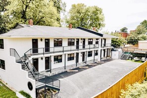A two-story building with a flat roof, multiple windows, and a central staircase. - Luxe King Studio w/ Amazing View ~ Free Parking & WiFi (Memphis)