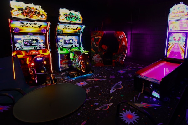 Arcade game room with commercial arcade games set on free play.