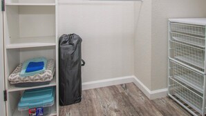 A walk-in closet with open shelves, a hanging rod, and a storage unit with bins. - Entire home remodeled & 1 mile to Kenai River & 1/2 block to Peninsula Hospital (Soldotna)