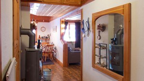 A compact living space with a kitchen area, a dining table, and a seating area.