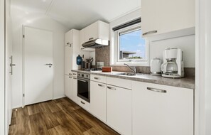 Fridge, stovetop, dishwasher, coffee/tea maker