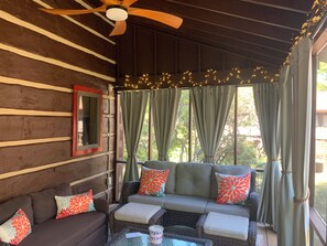 A cozy outdoor seating area with a ceiling fan, string lights, and a view of greenery outside. - Cozy Mountain Cabin Nelson 151 near Bold Rock Cidery and DB Brewery (Roseland)