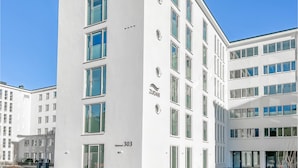 A modern building with multiple floors, large windows, and a clean, white facade. - 2 bedroom amazing apartment in Binz OT Prora (Binz OT Prora)