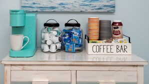 A coffee bar setup with a coffee maker, mugs, and coffee creamer. - 300ft to the Beach • Central A/C, Linens & Towels, Beach Badges & Gear Included (Seaside Heights)
