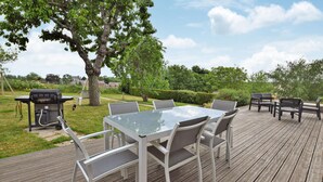 An outdoor deck with a table and chairs, a grill, and a bench. - Awesome home in Marcey-les-Grèves with WiFi (Marcey-les-Grèves)