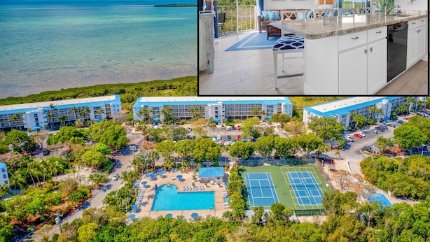An aerial view of a resort with a swimming pool, tennis court, and multiple buildings. - 🏝️OCEANFRONT PARADISE AWAITS YOU🏖️ (Tavernier)