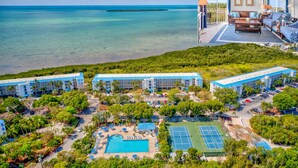 A resort with multiple buildings, a swimming pool, tennis courts, and a view of the ocean. - 🏝️OCEANFRONT PARADISE AWAITS YOU🏖️ (Tavernier)