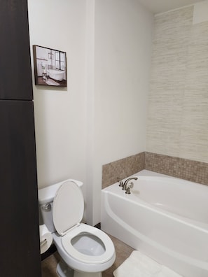 Bathtub, hair dryer, towels, soap