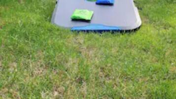 A grassy area with a blue mat and a blue bag labeled "East Point."