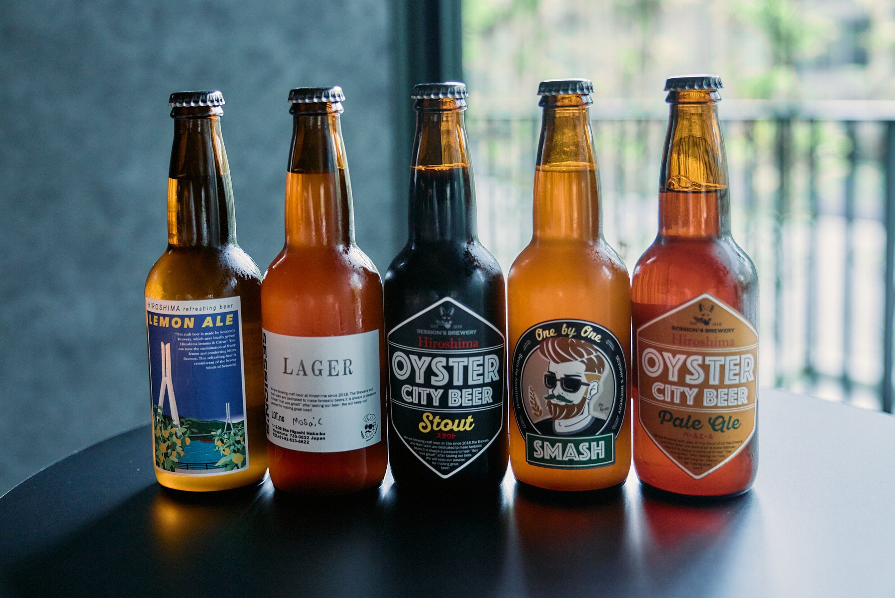 Five bottles of beer on a table.
