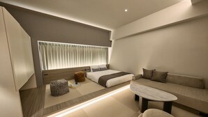 A modern bedroom with a bed, sofa, and a small table. - fav HIROSHIMA STADIUM (Hiroshima)