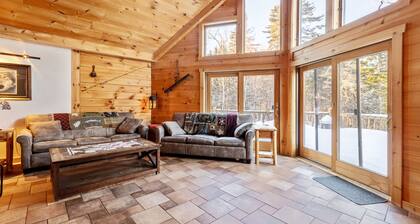 Experience the rustic charm of a log cabin chalet nestled on 14 private acres.