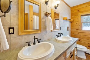A bathroom with two sinks, a mirror, a towel rack, and a window. - Cozy Vermont Log Cabin Chalet Only Minutes from Jay Peak (Montgomery)