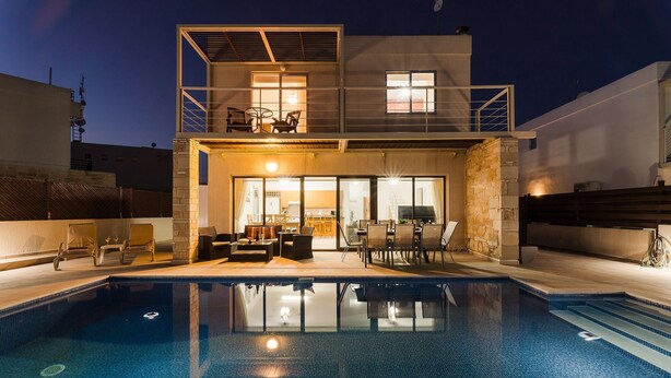 A modern two-story house with a swimming pool, outdoor furniture, and a balcony. - Villa Oleander - 4 bedroom Villa with Private Heated Pool, Hot Tub, Stunning Views (Paphos)