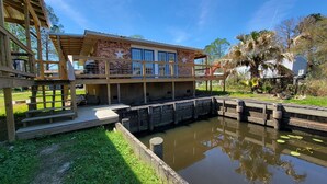 A two-story house with a deck and a pond. - Our Happy Place! (Springfield)