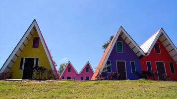 A row of colorful triangular houses with a clear sky.