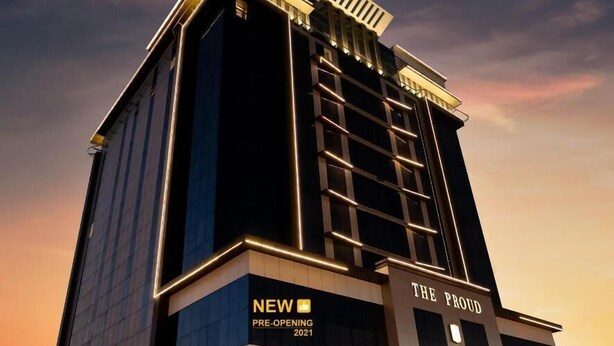 A modern hotel building with a prominent sign indicating a pre-opening in 2021. - The Proud Hotel (Al Khobar)
