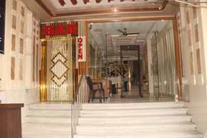 A hotel entrance with a glass door, a staircase leading inside, and a sign indicating the bar is open. - HOTEL WORTH PAHARGANJ (New Delhi)