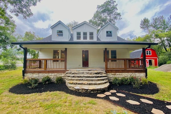 Front of the home with gorgeous porch and rocking chairs