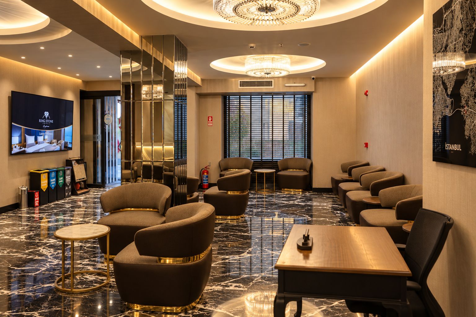 Un hall d’hôtel au design moderne, avec un grand lustre, un espace salon comprenant des canapés et des tables, et un écran de télévision qui affiche une image d’une chambre.