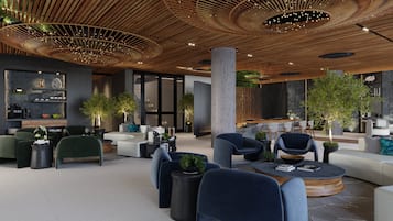 Relax in our inviting lobby, featuring a spacious seating area, communal coffee table, and bar for refreshments.