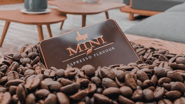 A coffee bean display with a Villiger Mini Espresso Flavour tin in a modern interior setting. - Oriana Hotel 2 (Hanoi)
