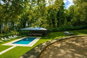 Seasonal outdoor pool, open 10:00 AM to 7:00 PM, pool umbrellas