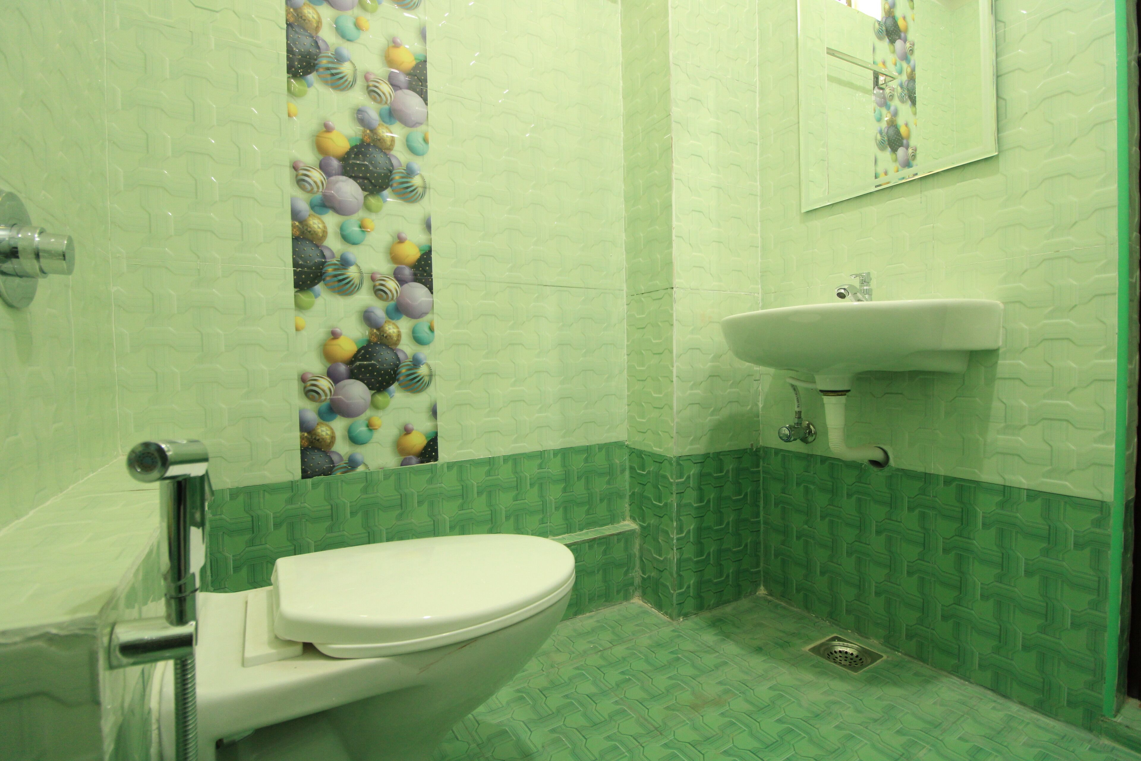 A bathroom with a toilet, sink, and a shower area.