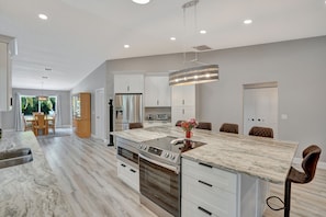 Enjoy cooking in this well-equipped kitchen with a large island, oven, and ample storage.